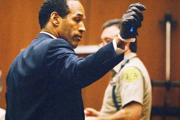 O. J. Simpson muestra muy llamativamente los guantes que le hicieron probarse
