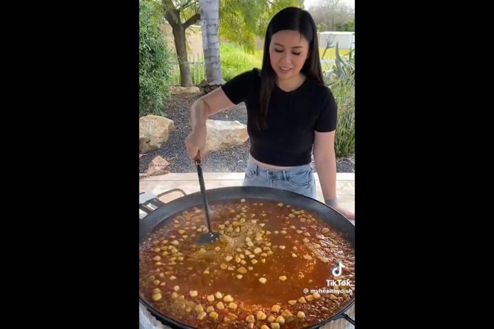 La usuaria de TikTok preparando una paella