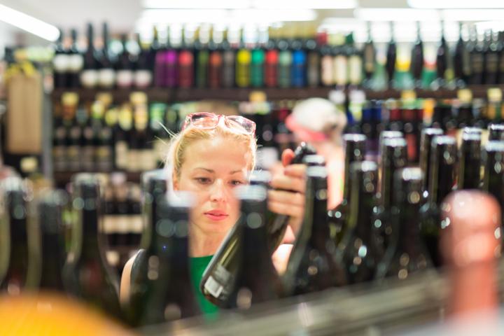 Imagen de archivo de una persona escogiendo aceite de oliva en un supermercado.