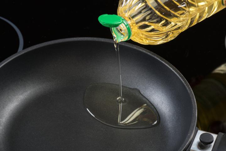 Echando aceite en una sartén.