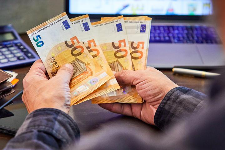 Una persona contando dinero, en una imagen de archivo