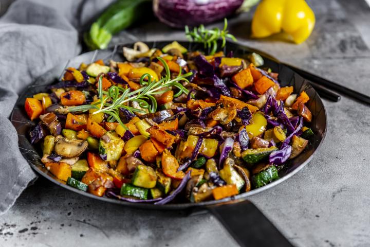 Una sartén con verduras.