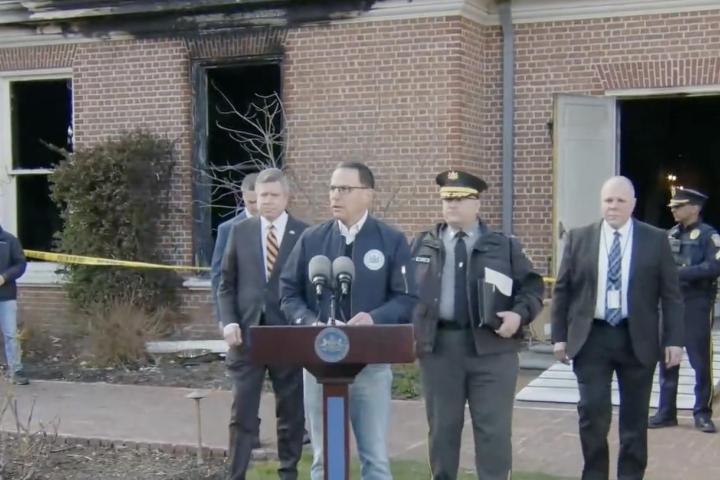 Rueda de prensa del gobernador Josh Shapiro delante de su residencia oficial, en la que se pueden ver los daños causados por el fuego.