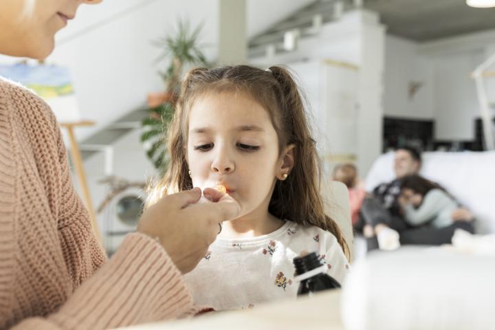 Una niña toma su medicación.