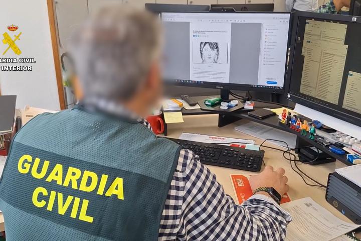 Un agente de la Guardia Civil trabaja en el expediente del llamado "crimen de Reyes", con el retrato robot de la asesinada en la pantalla.