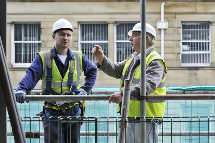 Trabajadores de la construcción hablando sobre la obra