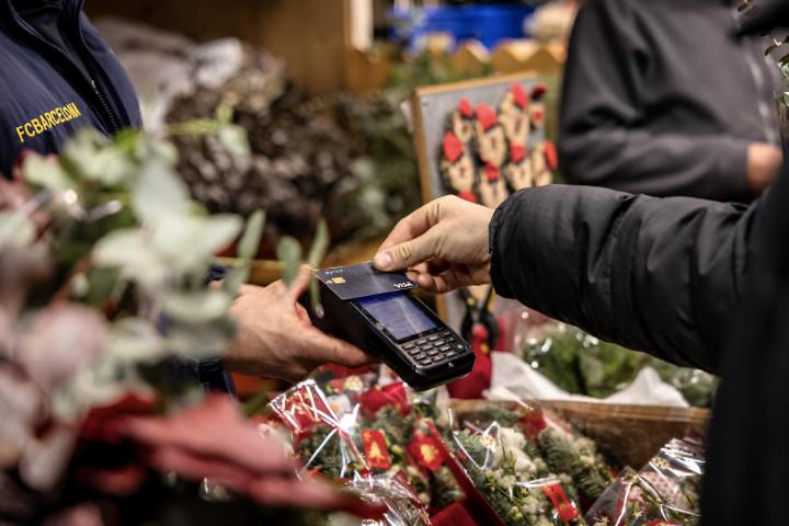 Un hombre pagando con tarjeta en un mercado navideño de Barcelona