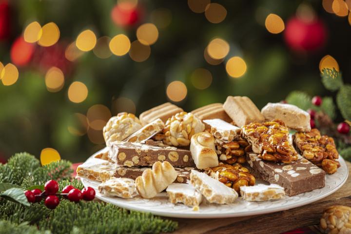 Varios turrones emplatados con decoración navideña al lado