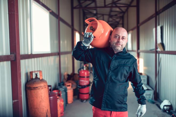 Un hombre cargando una bombona de butano, en una imagen de archivo.