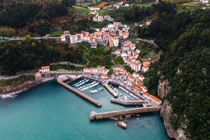 alt="alt="Aerial view of Elantxobe town and harbour in Vizcaya Basque Country Spain showing the green waters of Mar Cantabrico and the boats during 2022 trip to Spain.""