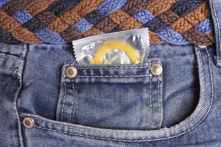 Condom in jeans pocket close up