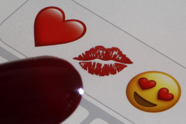 PARIS, FRANCE - FEBRUARY 14: In this photo illustration, emoji or emoticon representing a heart, lips and heart-shaped eyes are displayed on the screen of an iPhone on Valentine's Day on February 14, 2020 in Paris, France. Valentine's Day is known as the Lovers' Day and the celebration of love and romance in many parts of the world. (Photo by Chesnot/Getty Images)