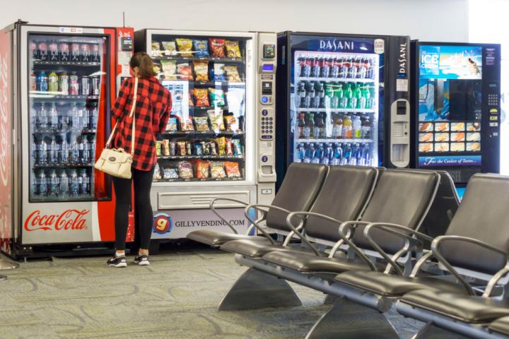 A woman at a vending machine inside Miami International Airport. (Photo by: Jeffrey Greenberg/Universal Images Group via Getty Images)