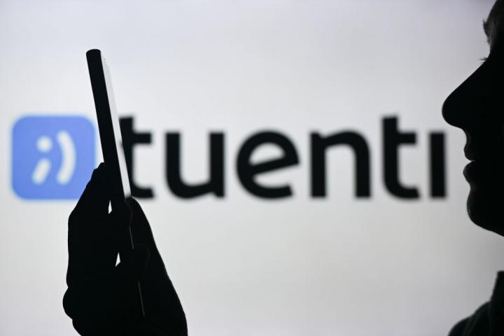 Teléfono móvil frente al logo de Tuenti