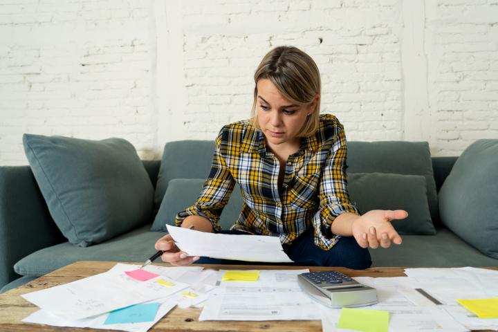 Retrato de jovenempresaria preocupada y desesperada contable con domicilio o finanzas de pequeñas empresas sintiéndose estresada sin poder pagar deudas, facturas, alquiler y gastos. En problemas financieros