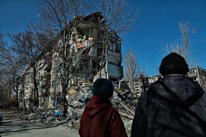 Un hombre y una mujer observan un edificio residencial destruido por un bombardeo ruso, el 23 de marzo de 2026, en Druzhkivka (Ucrania).