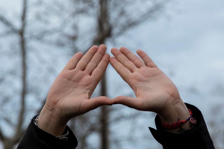 MADRID, SPAIN - MARCH 08: A women's rights supporter gives a feminist hand symbol during a gathering after a mural celebrating a diverse array of women was vandalized today with black paint during International Women's Day on March 08, 2021 in Madrid, Spain. The mural had presented an array of famous women from around the world, including Nina Simone, Rosa Parks, Frida Kahlo and the Red Army sniper Lyudmila Pavlichenko. (Photo by Pablo Blazquez Dominguez/Getty Images)