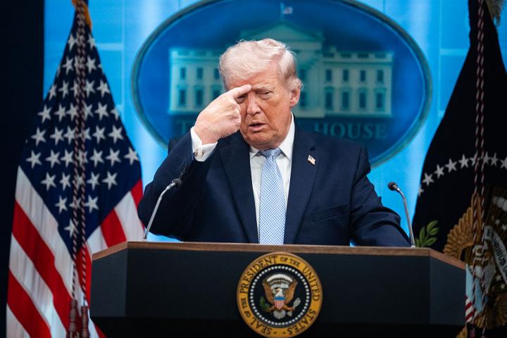 UNITED STATES - APRIL 6: President Donald Trump mimics a Iranian protester being shot, while he conducts a news conference about the war in Iran in the White House briefing room on Monday, April 6, 2026. (Tom Williams/CQ-Roll Call, Inc via Getty Images)