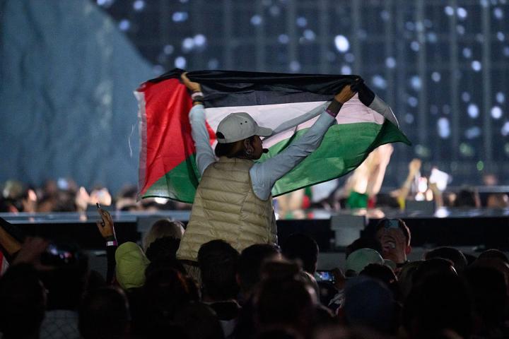Una mujer muestra un bandera palestina en Eurovisión 2025