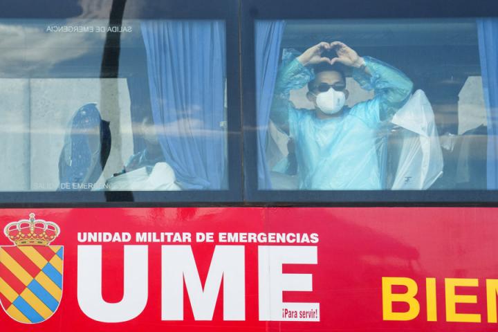 Uno de los pasajeros evacuados este lunes en Granadilla de Abona, saluda desde un autobús de la UME con un 'corazón' en señal de agradecimiento
