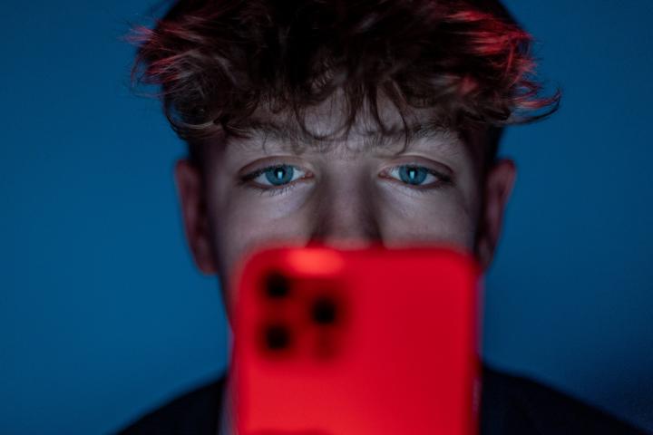 Foto de archivo de un adolescente usando el móvil para acceder a redes sociales