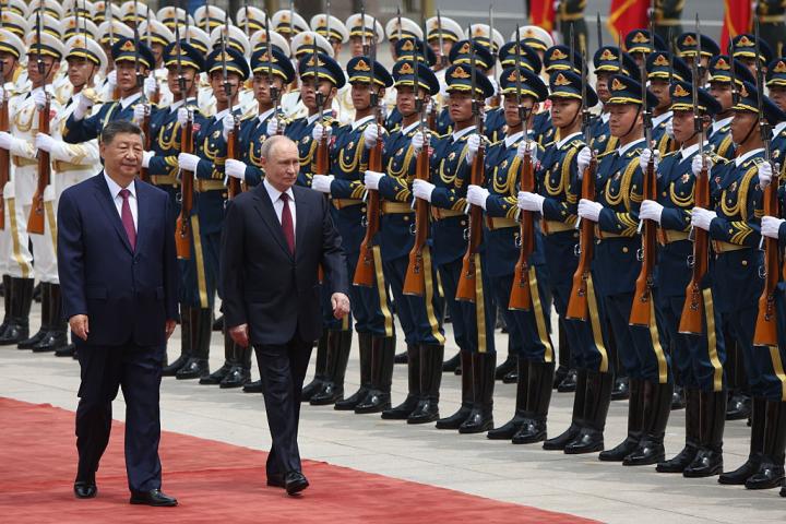 El presidente ruso Vladimir Putin y el chino Xi Jinping pasan revista a los soldados que dan la bienvenida al líder ruso, el 20 de mayo de 2026, en Pekín.