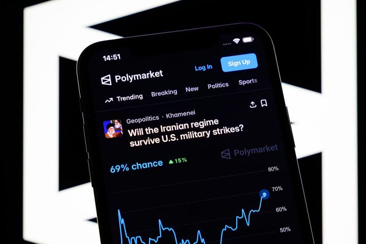 A betting page on the potential fall of the Iranian regime by June 30 appears on the Polymarket platform on a smartphone in Creteil, France, on March 9, 2026, during a massive insider trading scandal involving bets on the recent military strikes in Iran. (Photo by Samuel Boivin/NurPhoto via Getty Images)