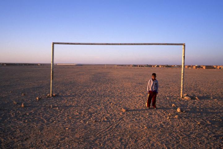 TINDOUF - MAY 5: A boy on the soccer field of the Sahrawi refugee camps located in Algerian territory since 1976, seen on May 5, 2002, Tindouf, Algeria (Photo by Xurxo Lobato / Getty Images)