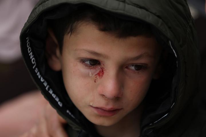 15 March 2026, Palestinian Territories, Tammun: A child bids farewell to Ali Khaled Bani Odeh, 37, his wife Waad Othman Bani Odeh, 35, and their two children, 5-year-old Mohammad and 7-year-old Othman, who were killed by Israeli occupation forces during a raid on the town of Tammun, south of Tubas, in the northern West Bank. Photo: Ayman Nobani/dpa (Photo by Ayman Nobani/picture alliance via Getty Images)