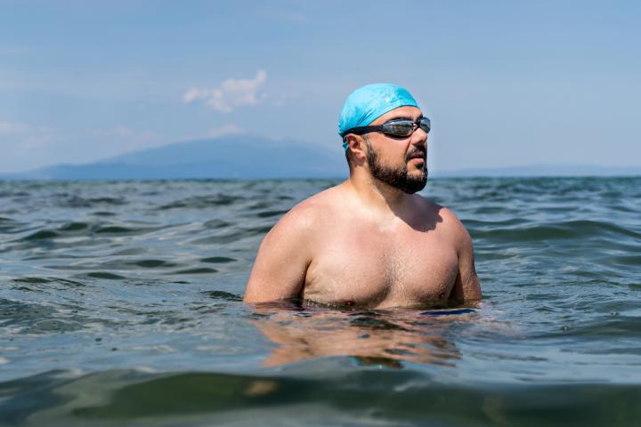 Un hombre se relaja dentro del agua durante un baño en el mar
