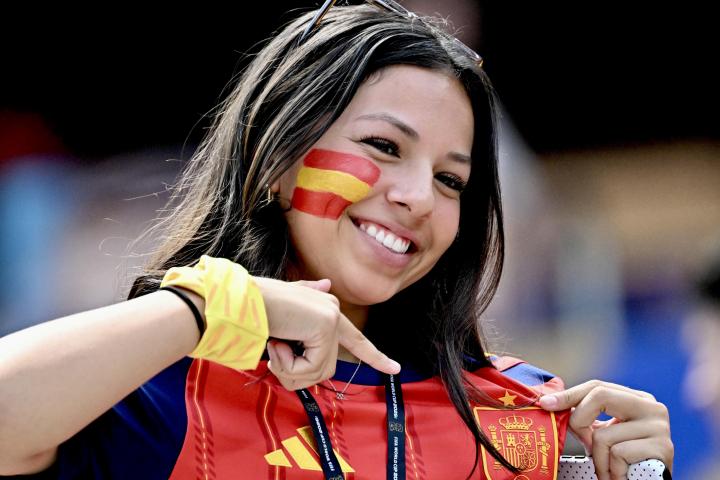 Un aficionado de España muestra el escudo del equipo
