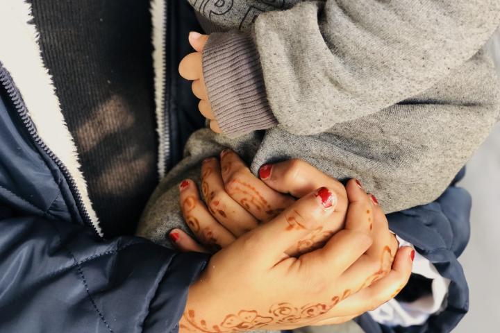 Una madre sostiene a su hija en uno de los "Espacios Seguros para Bebés" que Acción contra el Hambre mantiene en Gaza.
