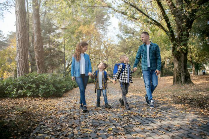 Una familia paseando por el parque mientras rien