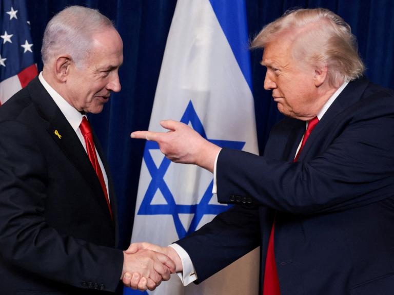 El presidente de EEUU, Donald Trump, señala con el dedo al primer ministro israelí, Benjamin Netanyahu, mientras se dan la mano en el club Mar-a-Lago de Trump en Palm Beach (Florida), el 29 de diciembre de 2025.